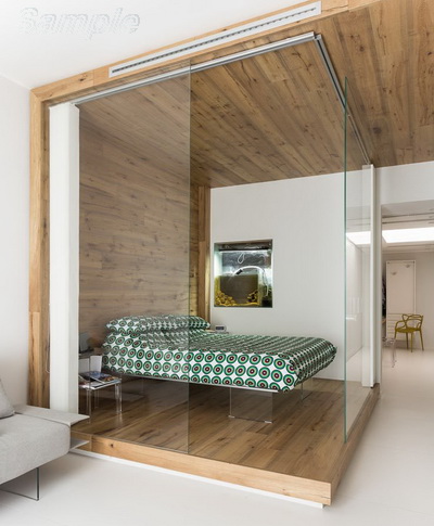 Glass partitions separate the sleeping area from other functional areas of the apartment