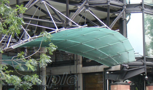 Glass canopy of complicated shape on truss rods with frame understructure