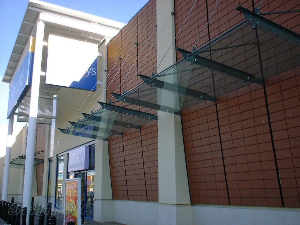 Glass canopy on truss rods with cantilever understructures