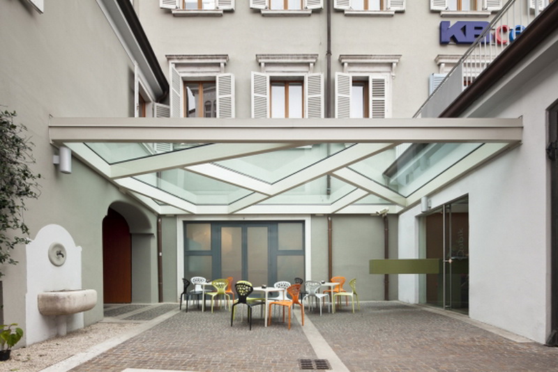 Overhang with glass element filling in hotel courtyard