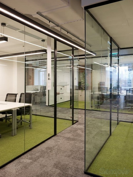 Glass office partitions with a swing door in an aluminum frame
