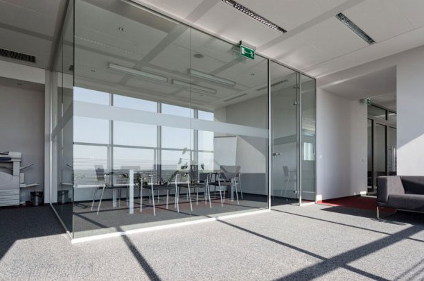 Glass partitions with a swing door in an aluminum frame