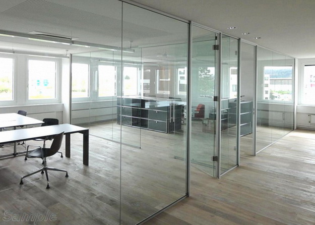 Glass office partitions with a swing door in an aluminum frame