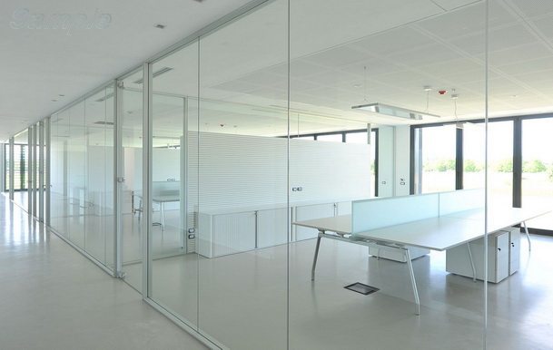 Glass office partitions with a swing door in an aluminum frame