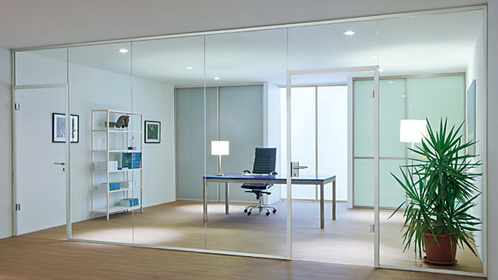 Glass office partitions with a swing door in an aluminum frame