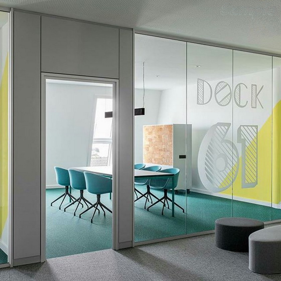 Glass office partitions with a swing door in an aluminum frame