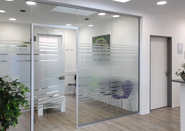 Glass office partitions with a swing door in an aluminum frame