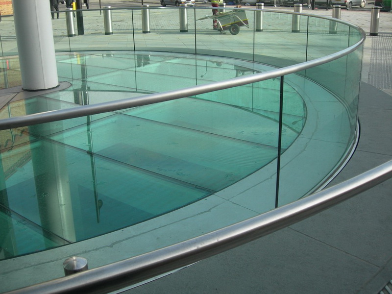 Model GS-01. Profile-mount glass railing with round metal handrail